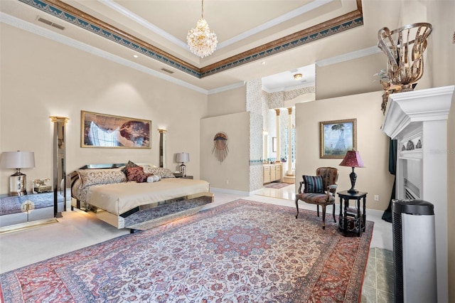 bedroom featuring a high ceiling, a notable chandelier, a fireplace, a tray ceiling, and ornamental molding