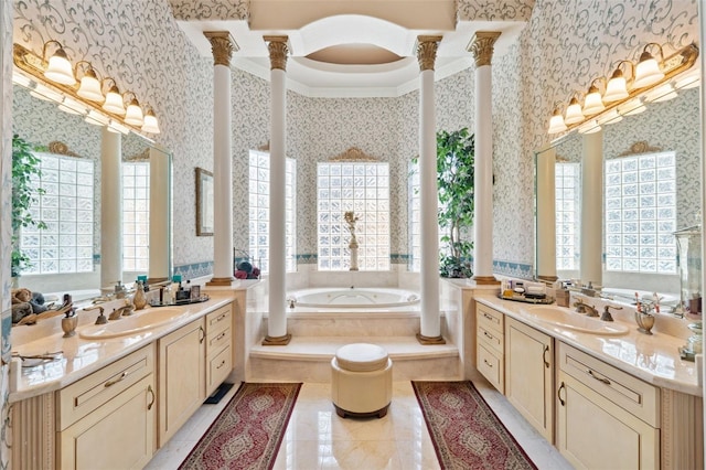 bathroom with decorative columns, a healthy amount of sunlight, and wallpapered walls