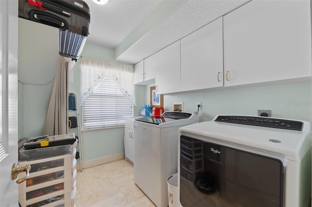 laundry area with baseboards, marble finish floor, cabinet space, and washer and dryer