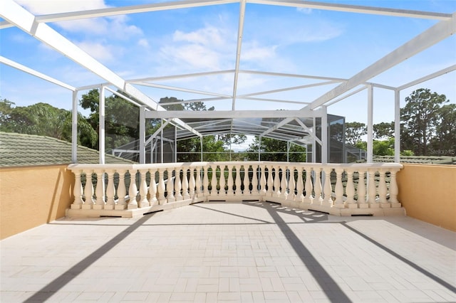 view of patio / terrace featuring glass enclosure