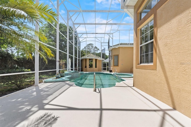 view of pool featuring a patio, a lanai, and a pool with connected hot tub