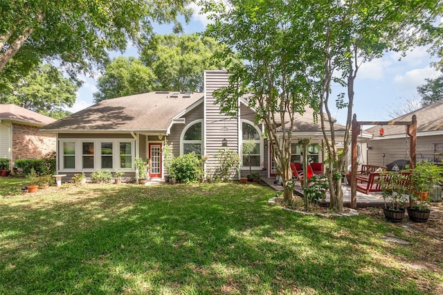 back of property featuring a patio area, a yard, and a chimney