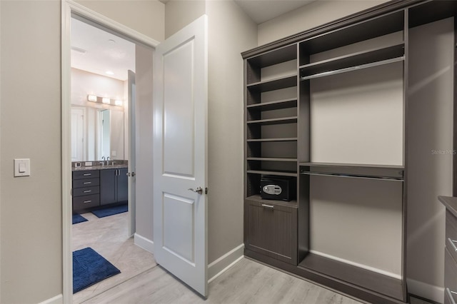 spacious closet with light wood finished floors