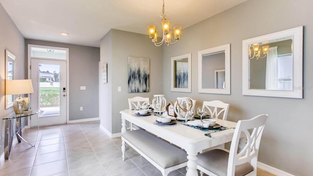 dining room featuring baseboards, light tile patterned floors, and an inviting chandelier