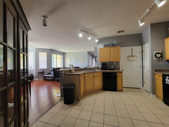 kitchen with visible vents, light brown cabinets, open floor plan, rail lighting, and dishwasher
