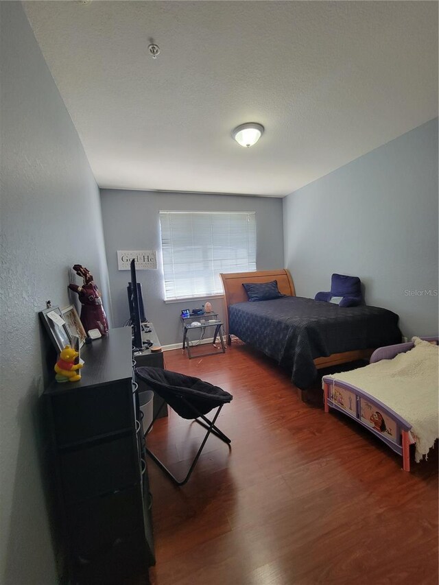 bedroom with wood finished floors