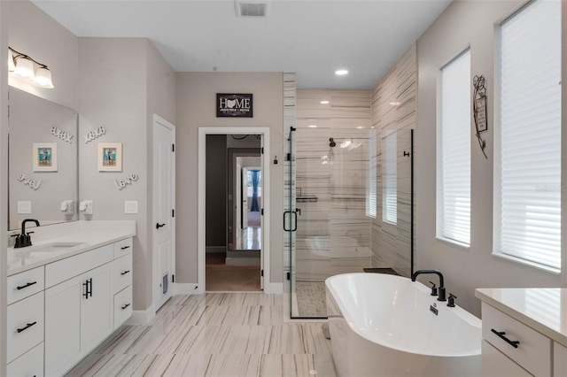 3332 Lone Cypress Pt, Oviedo, FL 32765 - full bathroom with vanity, a shower stall, a freestanding bath, baseboards, and recessed lighting