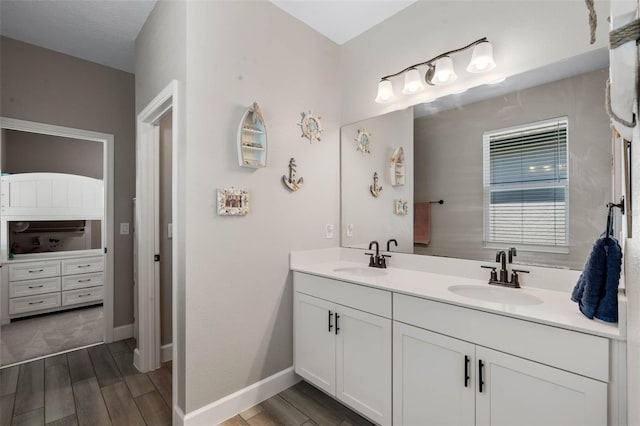 3332 Lone Cypress Pt, Oviedo, FL 32765 - bathroom with double vanity, wood finished floors, and baseboards