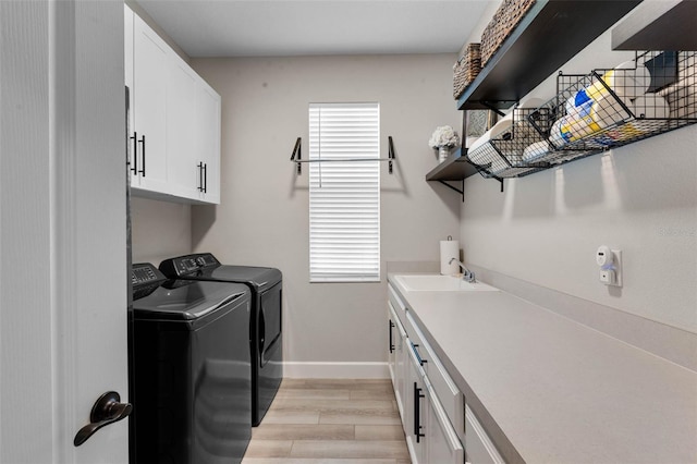 3332 Lone Cypress Pt, Oviedo, FL 32765 - laundry area featuring cabinet space, washer and dryer, light wood-style floors, and baseboards