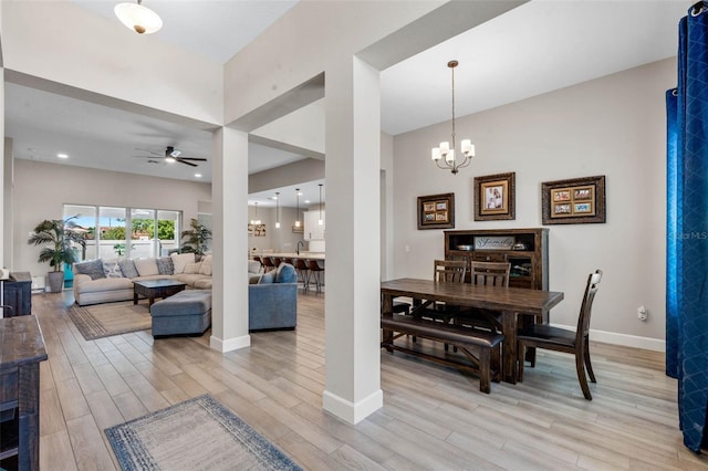 3332 Lone Cypress Pt, Oviedo, FL 32765 - dining space with a ceiling fan, light wood-style floors, baseboards, and a chandelier