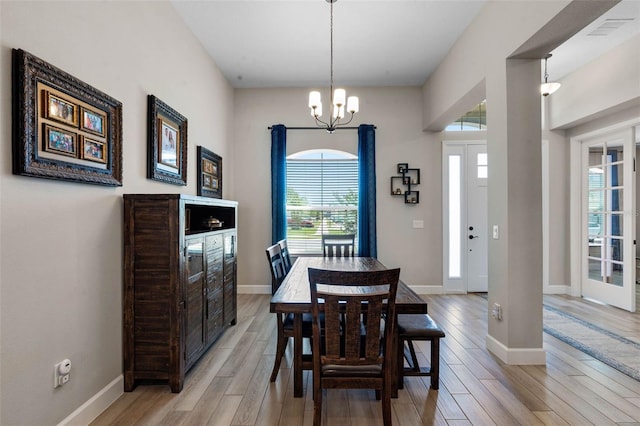 3332 Lone Cypress Pt, Oviedo, FL 32765 - dining space featuring light wood-style flooring, plenty of natural light, a chandelier, and baseboards