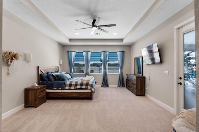 3332 Lone Cypress Pt, Oviedo, FL 32765 - bedroom featuring a raised ceiling, light carpet, baseboards, and ceiling fan