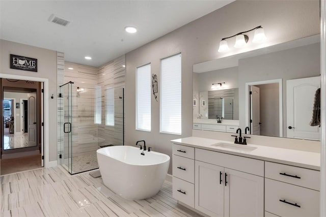 3332 Lone Cypress Pt, Oviedo, FL 32765 - bathroom featuring a shower stall, vanity, a soaking tub, recessed lighting, and baseboards
