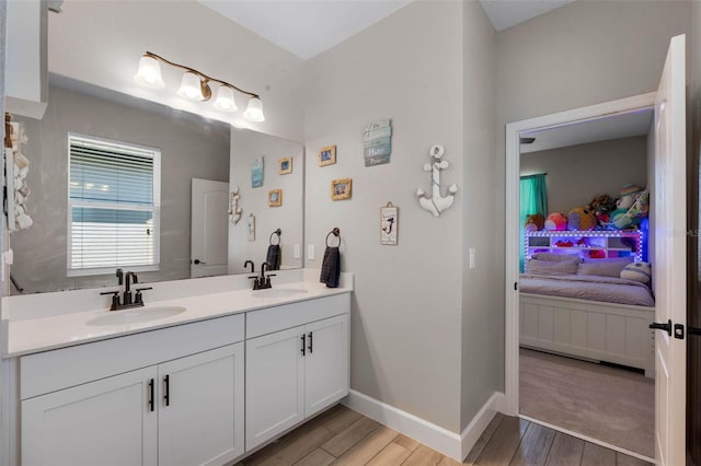 3332 Lone Cypress Pt, Oviedo, FL 32765 - bathroom featuring connected bathroom, wood finished floors, double vanity, and baseboards