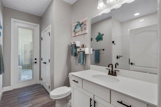 3332 Lone Cypress Pt, Oviedo, FL 32765 - bathroom featuring wood finished floors, vanity, tiled shower, toilet, and baseboards