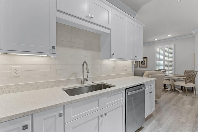 3078 Isles Way, New Smyrna Beach, FL 32168 - kitchen featuring stainless steel dishwasher, a sink, decorative backsplash, white cabinetry, and light wood finished floors