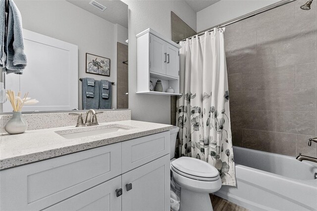 3078 Isles Way, New Smyrna Beach, FL 32168 - bathroom with vanity, shower / tub combo with curtain, toilet, and wood finished floors