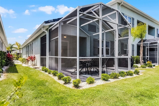 3078 Isles Way, New Smyrna Beach, FL 32168 - view of side of home with a yard, a lanai, a patio area, and stucco siding