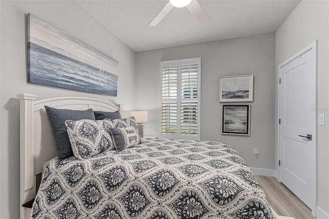3078 Isles Way, New Smyrna Beach, FL 32168 - bedroom featuring wood finished floors, baseboards, a ceiling fan, and a textured ceiling