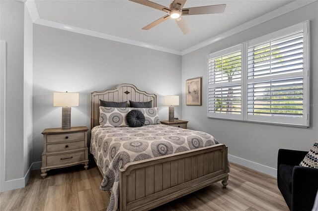3078 Isles Way, New Smyrna Beach, FL 32168 - bedroom featuring baseboards, ornamental molding, wood finished floors, and a ceiling fan