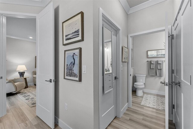 3078 Isles Way, New Smyrna Beach, FL 32168 - hallway featuring light wood finished floors, baseboards, and crown molding