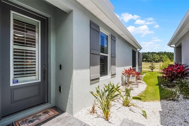 3078 Isles Way, New Smyrna Beach, FL 32168 - doorway to property featuring stucco siding