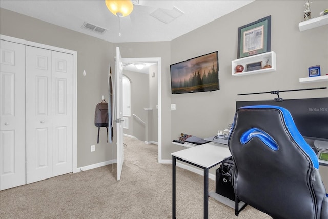 office space featuring carpet flooring, baseboards, visible vents, and ceiling fan