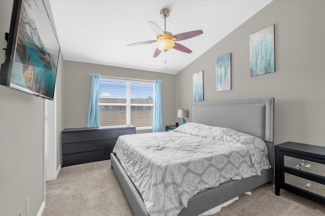 bedroom featuring a ceiling fan, baseboards, light colored carpet, and vaulted ceiling