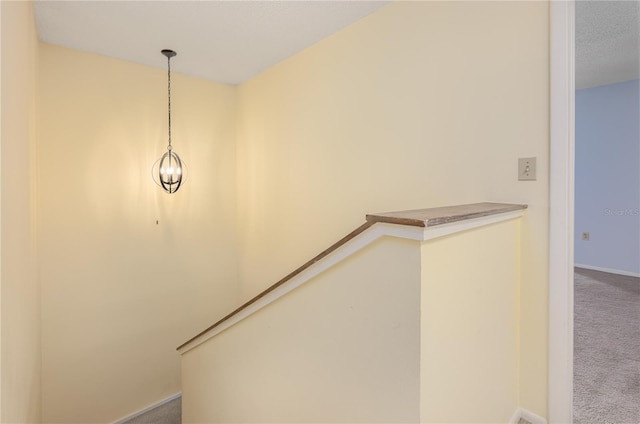 staircase with baseboards and carpet floors