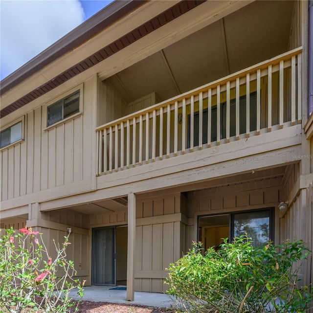 exterior space featuring board and batten siding and a balcony