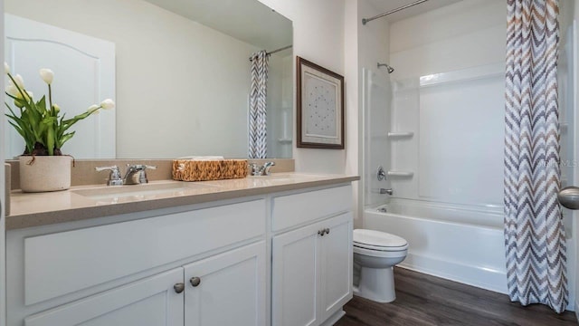 8375 Madrid St, Lakeland, FL 33810 - bathroom with wood finished floors, double vanity, toilet, a sink, and shower / tub combo