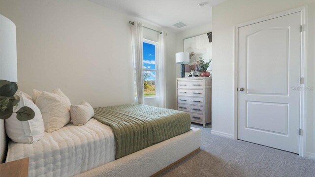 8375 Madrid St, Lakeland, FL 33810 - bedroom with baseboards, visible vents, and light carpet