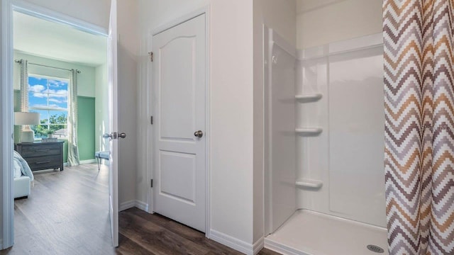 8375 Madrid St, Lakeland, FL 33810 - full bath with wood finished floors, a shower stall, and baseboards