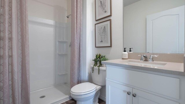 8375 Madrid St, Lakeland, FL 33810 - bathroom featuring toilet, a stall shower, and vanity