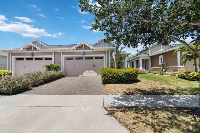 2423 Datura Loop, Saint Cloud, FL 34772 - craftsman-style house with driveway, an attached garage, stucco siding, and a front lawn