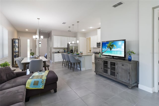 2423 Datura Loop, Saint Cloud, FL 34772 - living area with a chandelier, light tile patterned floors, recessed lighting, and baseboards