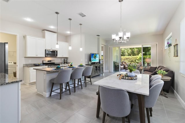 2423 Datura Loop, Saint Cloud, FL 34772 - dining space featuring washer / clothes dryer, a chandelier, baseboards, recessed lighting, and light tile patterned flooring