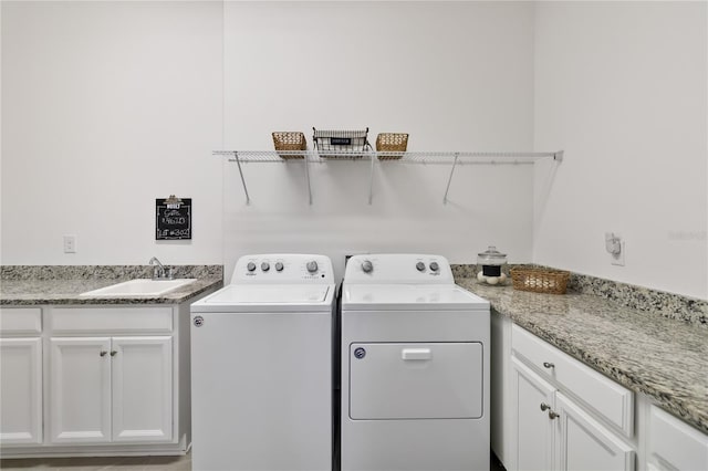 2423 Datura Loop, Saint Cloud, FL 34772 - laundry room featuring washer and clothes dryer and cabinet space