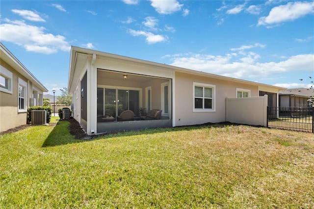 2423 Datura Loop, Saint Cloud, FL 34772 - rear view of house featuring a sunroom, central air condition unit, and stucco siding