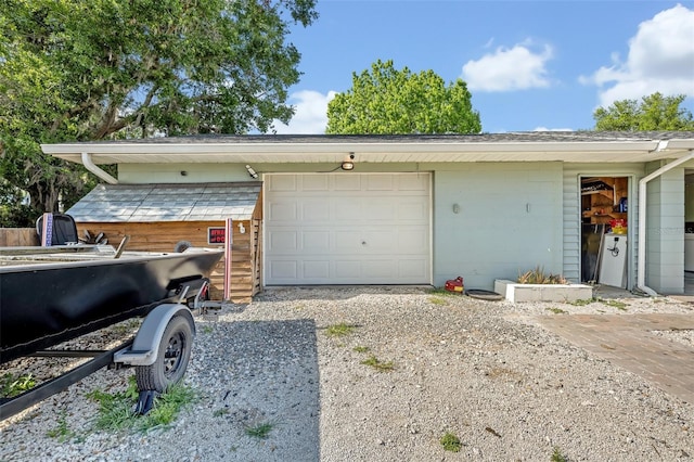 garage with gravel driveway