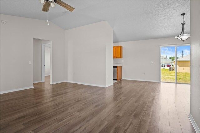 15 Sawfish Ln, Kissimmee, FL 34759 - unfurnished living room featuring ceiling fan, dark wood-style floors, baseboards, and lofted ceiling
