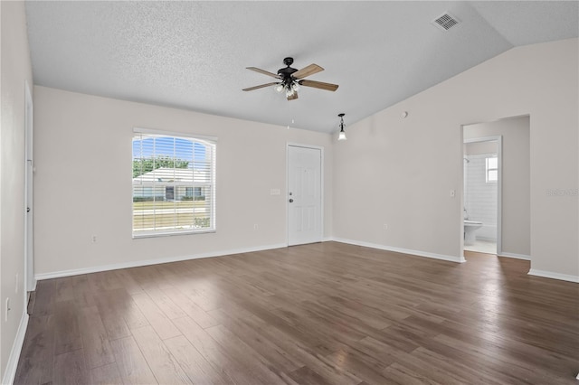 15 Sawfish Ln, Kissimmee, FL 34759 - empty room with a ceiling fan, baseboards, vaulted ceiling, visible vents, and dark wood-style floors