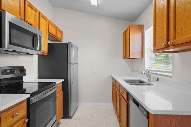 15 Sawfish Ln, Kissimmee, FL 34759 - kitchen with a sink, marble finish floor, brown cabinets, and stainless steel appliances