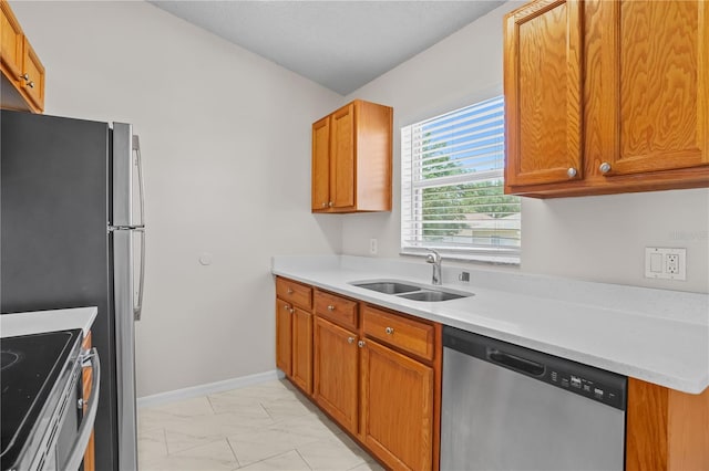 15 Sawfish Ln, Kissimmee, FL 34759 - kitchen with brown cabinets, a sink, light countertops, marble finish floor, and stainless steel appliances