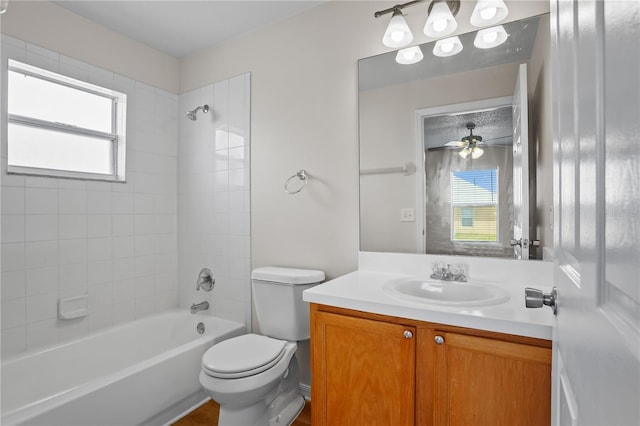 15 Sawfish Ln, Kissimmee, FL 34759 - bathroom featuring a healthy amount of sunlight, vanity, toilet, and shower / washtub combination