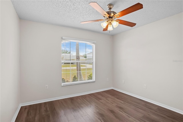 15 Sawfish Ln, Kissimmee, FL 34759 - unfurnished room featuring baseboards, ceiling fan, dark wood finished floors, and a textured ceiling