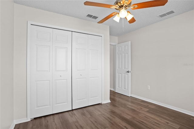 15 Sawfish Ln, Kissimmee, FL 34759 - unfurnished bedroom with baseboards, visible vents, dark wood-style floors, and a closet