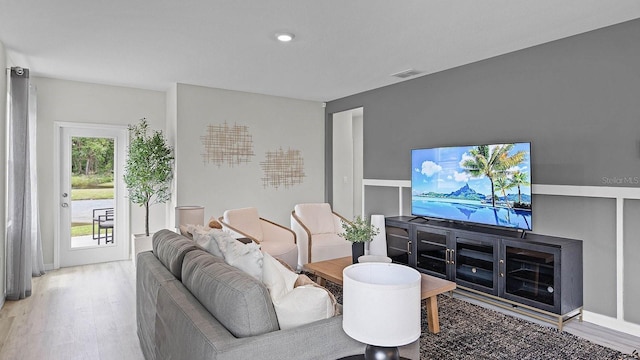 living room with wood finished floors and visible vents