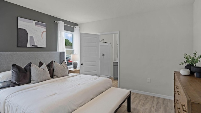 bedroom with light wood-style floors and baseboards