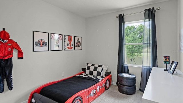 carpeted bedroom featuring baseboards